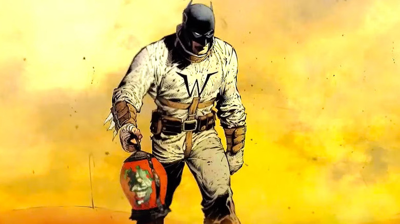 Batman walking with Joker's head in a jar