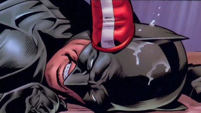 Wonder Woman's boot on Batman's face