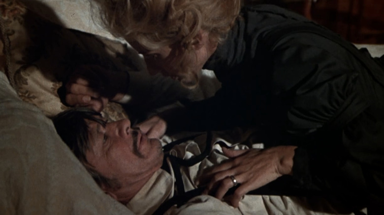 Jill Ireland's Amanda Starbuck lays on top of Charles Bronson's Graham Dorsey in a bed in From Noon till Three