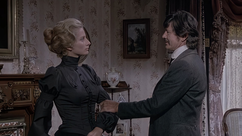 Jill Ireland's Amanda Starbuck stands opposite Charles Bronson's Graham Dorsey in a living room in From Noon till Three
