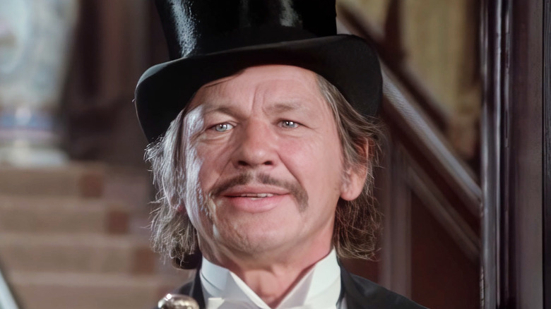 Charles Bronson's Graham Dorsey smiles in a top hat in From Noon till Three