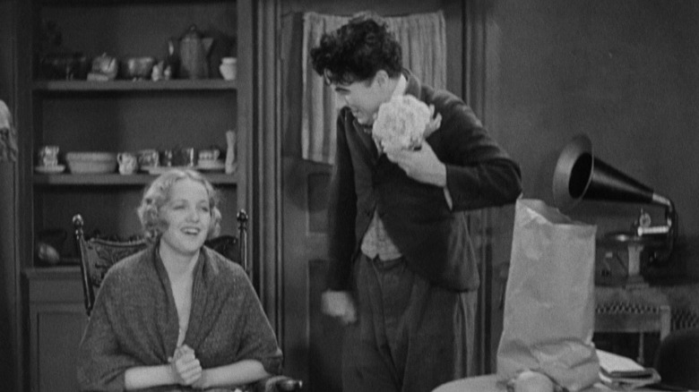 The Blind Girl and The Tramp laughing together in an apartment in City Lights