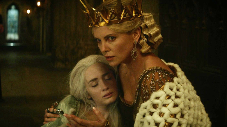 Charlize Theron as Ravenna clutches Emily Blunt as Freya in The Huntsman: Winter's War