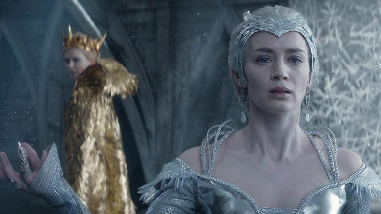 Emily Blunt as Freya looking concerned as Charlize Theron as Ravenna circles her in The Huntsman: Winter's War