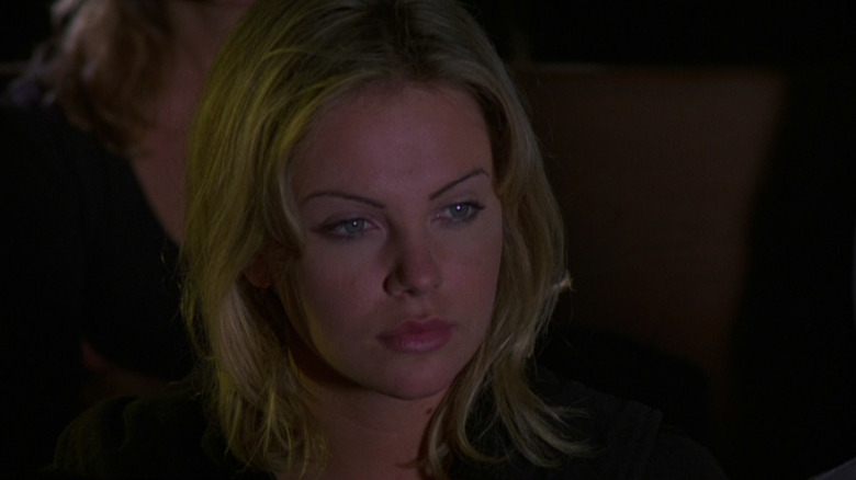 A random teenager who played Charlize the Turo looks at something in the kids corn III: Urban Harvest.