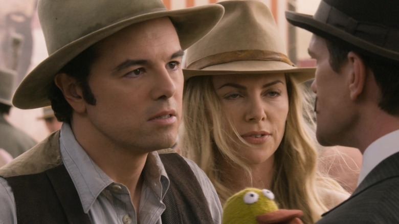 Seth MacFarlane as Albert Stark and Charlize Theron as Anna Barnes-Leatherwood square off with Neil Patrick Harris as Foy in A Million Ways to Die in the West