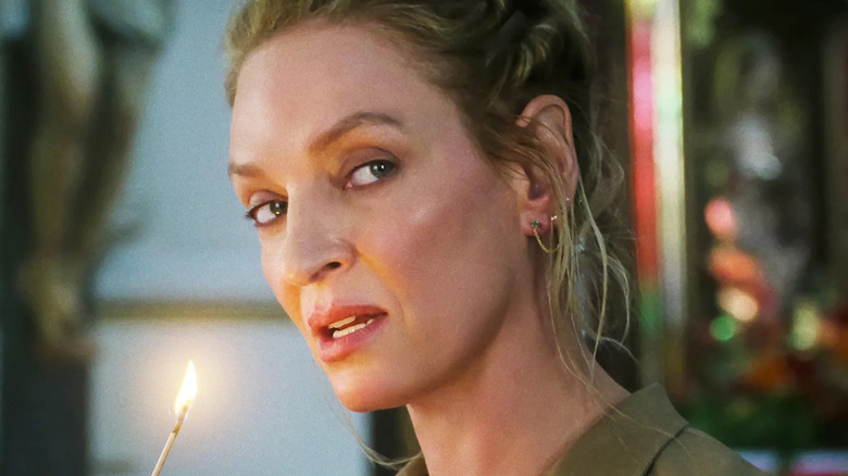 Uma Thurman as Discord lighting a match in The Old Guard 2