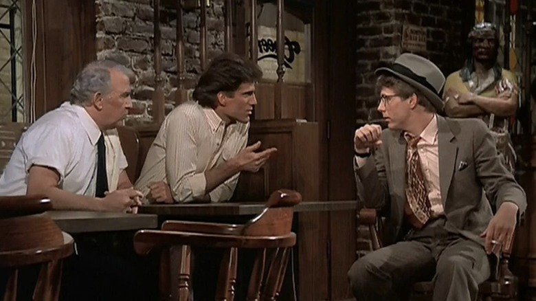 Nicholas Colasanto, Ted Danson as Sam Malone, and Harry Anderson as Harry the Hat forming a plan in Cheers