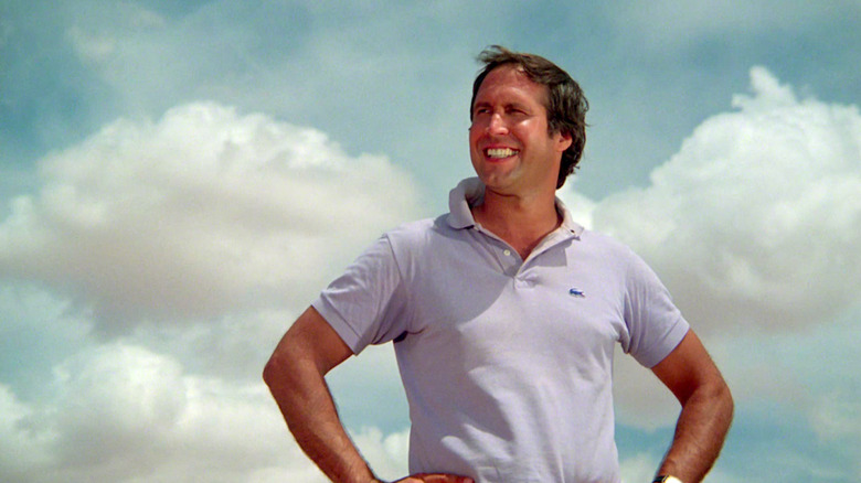 Chevy Chase stands with his hands on his hips in National Lampoon's Vacation