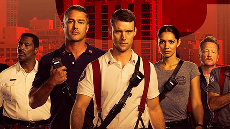 The cast of Chicago Fire walking toward the camera, tinted red