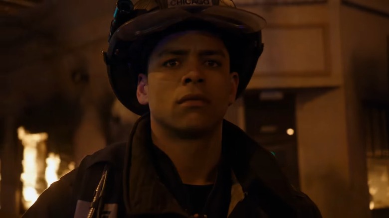 Charlie Barnett as Peter Mills looking afraid in front of a burning building