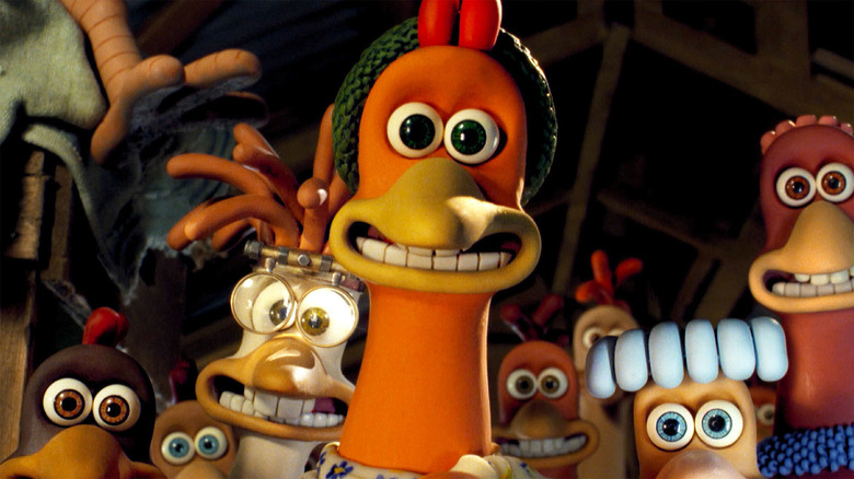 a smiling claymation rooster surrounded by claymation chickens