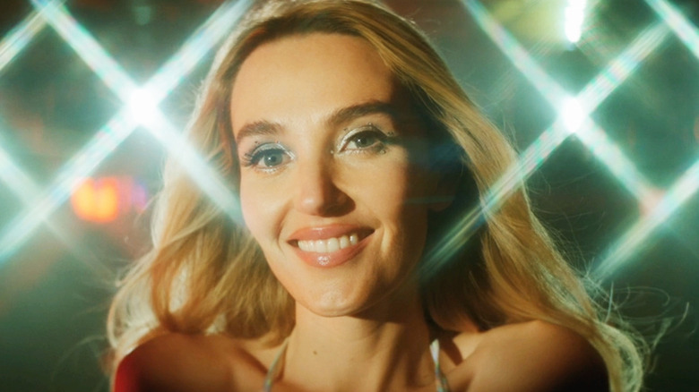 Chloe Fineman as Santa Monica smiles in closeup in Summer of 69