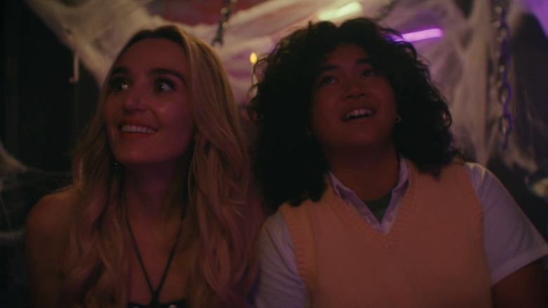Chloe Fineman as Santa Monica walks through a haunted house alongside Sam Morelos as Abby Flores in Summer of 69