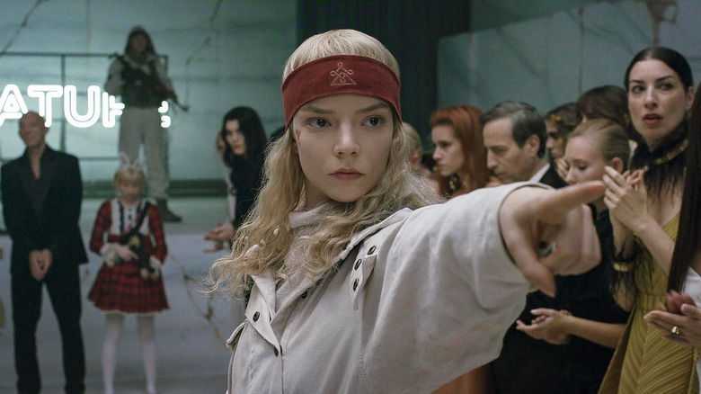 Anya Taylor-Joy as Joan pointing dramatically while surrounded by people in Sacrifice