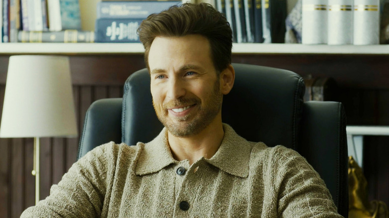Chris Evans's Reverend Drew Devlin sits in his office smiling in Honey Don't!