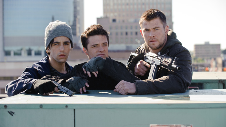 Josh Peck as Matt Eckert, Josh Hutcherson as Robert Kitner and Chris Hemsworth as Jed Eckert scout the enemy from a rooftop in Red Dawn