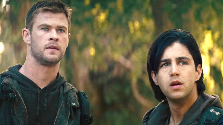 Jed and Matt in the woods, looking at something scary in Red Dawn