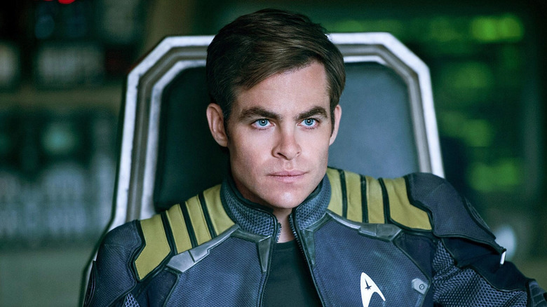 man in starfleet jacket sitting in a chair