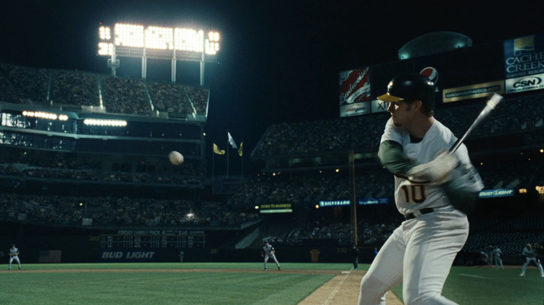 Chris Pratt's Scott Hatteberg swings at a ball in a baseball stadium in Moneyball