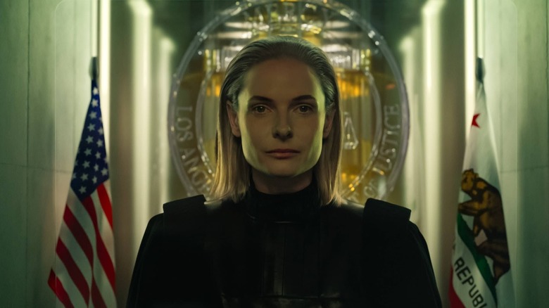 Rebecca Ferguson as Judge Maddox standing in front of flags in Mercy