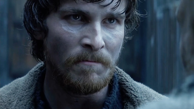 Quinn staring intensely at someone in Reign of Fire