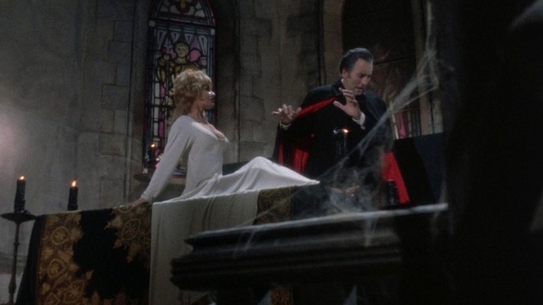 Christopher Lee as Dracula recoiling from a bosom protected by a crucifix in Dracula A.D. 1972