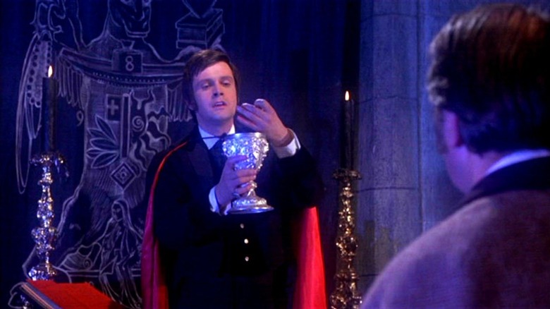 Ralph Bates as Lord Courtley holding cup in Dracula in Taste the Blood of Dracula