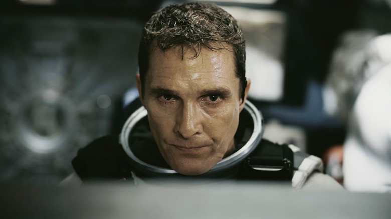 Matthew McConaughey's Joseph "Coop" Cooper looks tired covered in sweat while wearing a space suit in Interstellar