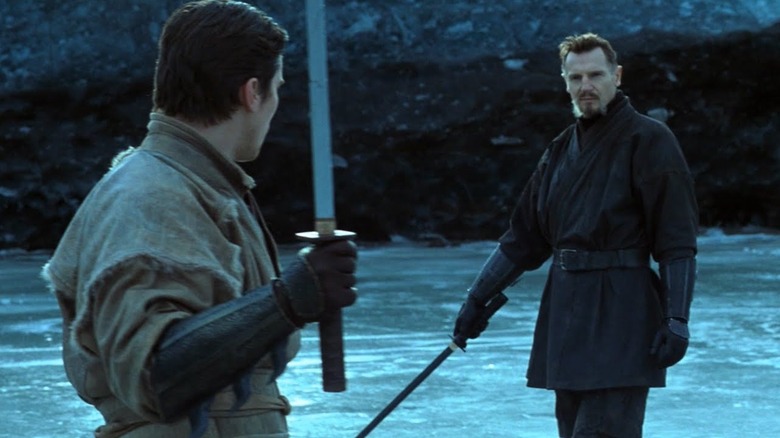 Christian Bale as Bruce Wayne wielding a sword, training with Liam Neeson as Ra's Al Ghul in "Batman Begins"