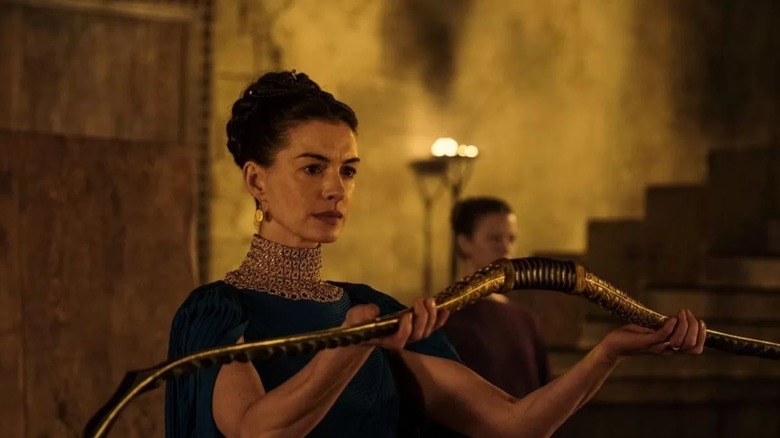 Penelope holding Odysseus' bow in The Odyssey