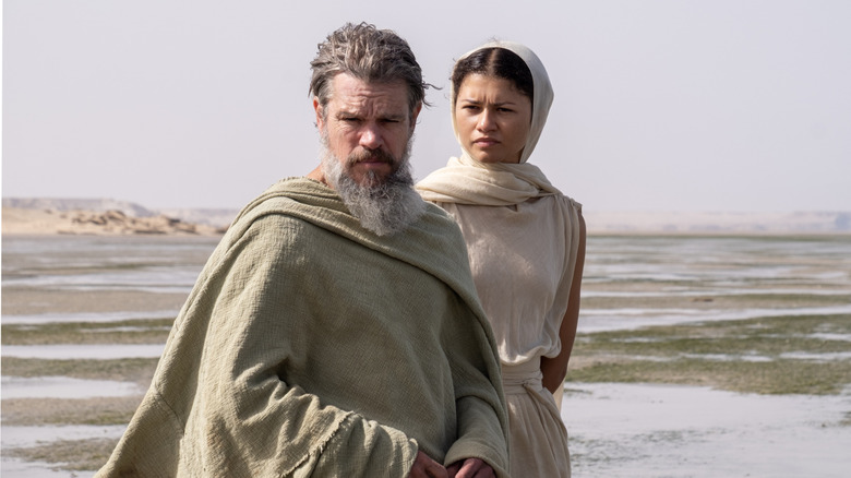 Odysseus and Athena stand on a beach in The Odyssey