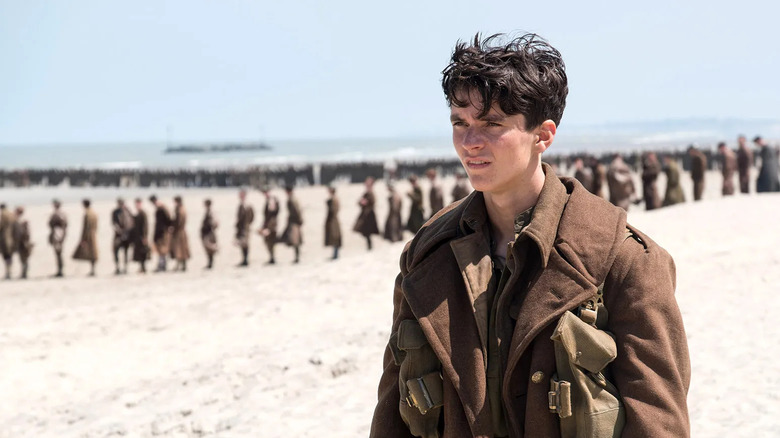 Tommy on the beach in front of a row of people in Dunkirk
