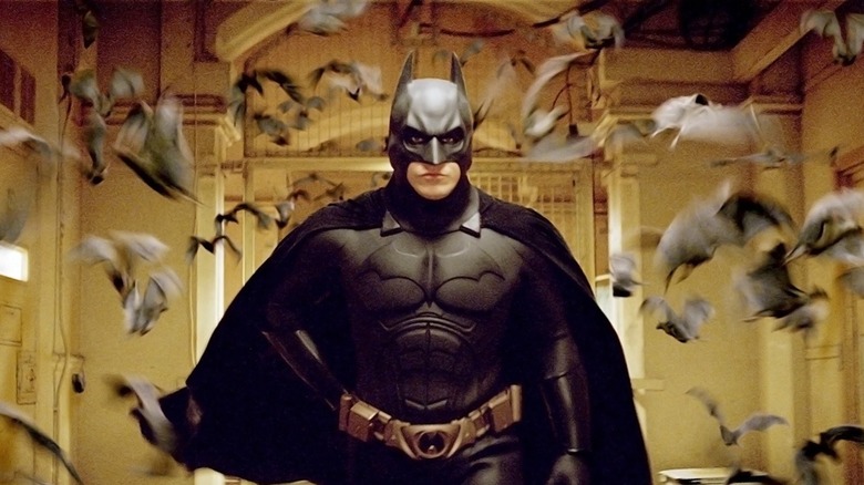 Christian Bale as Batman surrounded by bats in Batman Begins