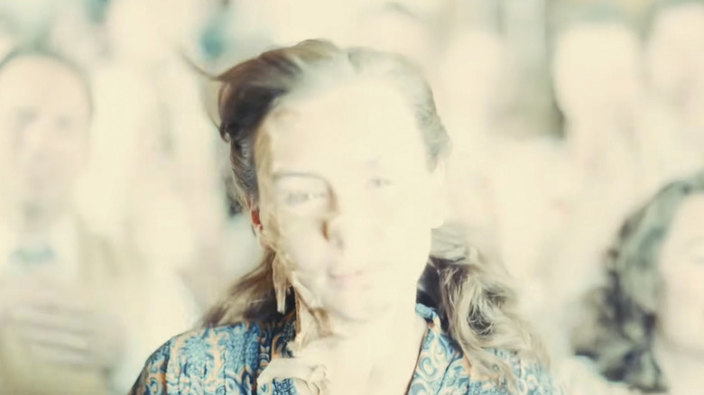 A young woman's skin is flapping off her face during Oppy's vision sequence in Oppenheimer