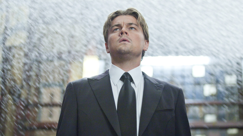 Don Cobb looking up as water falls around him in a dream in Inception