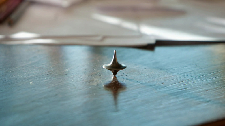 Cobb's top spinning on a table in Inception