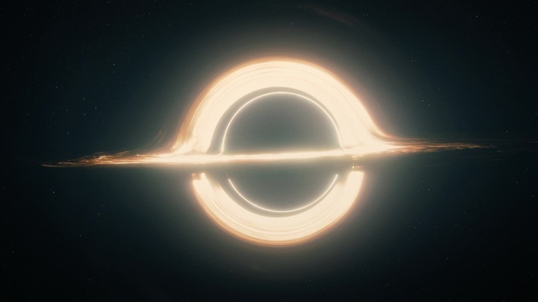 A black hole is depicted as a ring of yellow light suspended in space in Interstellar