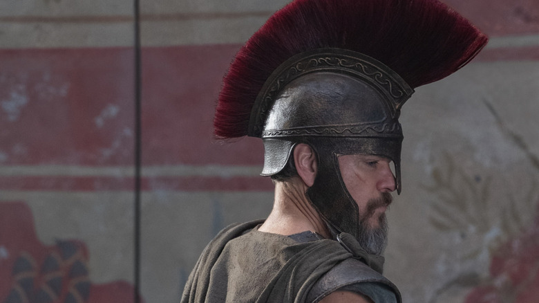Matt Damon as Odysseus wearing a helmet and armor in The Odyssey