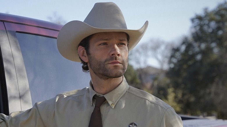 Jared Padalecki as Walker leaning on his truck in Walker
