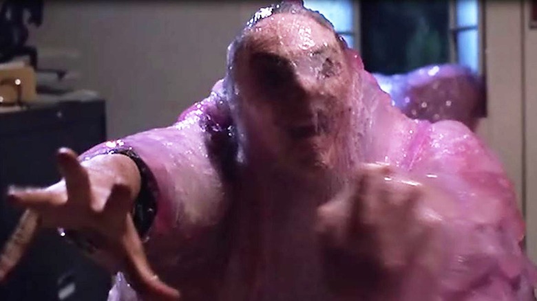 A man has been coated in Blob in The Blob.