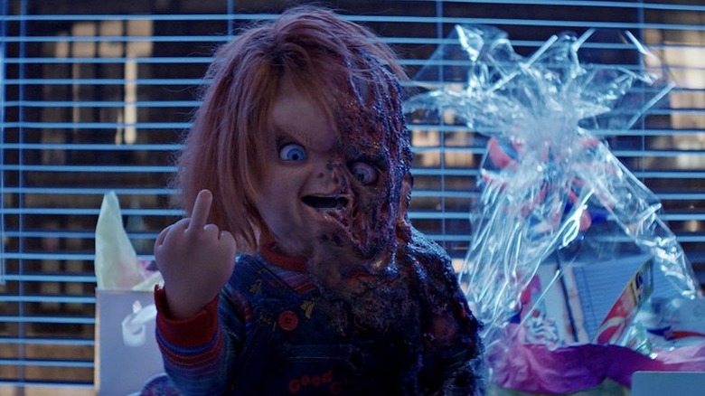 Partially Melted Chucky Flipping Off the Camera