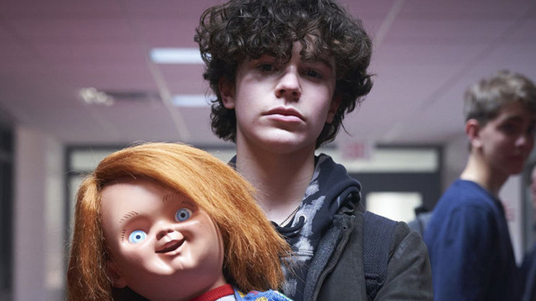 jake holding a chucky doll in the chucky tv show