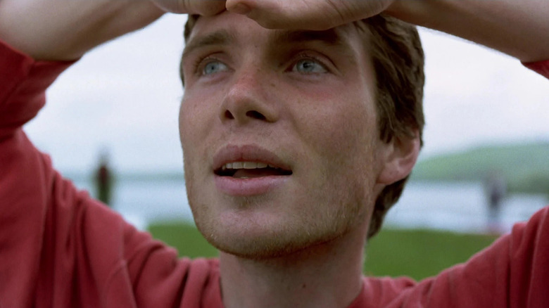 Cillian Murphy as Jim looking up at the sky in relief in 28 Days Later