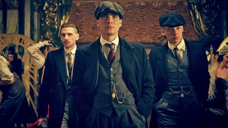 Arthur, Tommy and John Shelby walking through a club