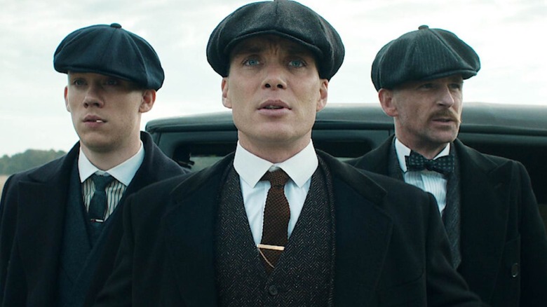 John, Tommy and Arthur Shelby together wearing peak caps