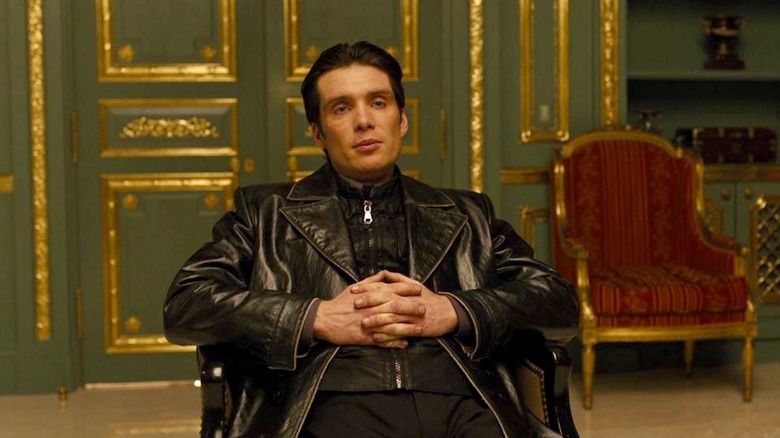 Raymond Leon looking like a leather sex god in a chair in the movie In Time