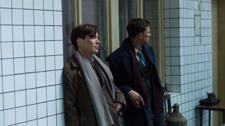 Jozef (Cillian Murphy) and Jan (Jamie Dornan) leaning against a wall in 