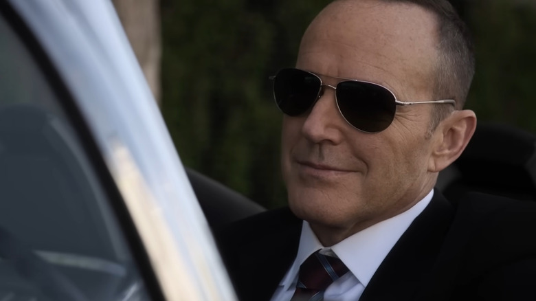 Agt. Phil Coulson sitting in his car with sunglasses on in Agents of S.H.I.E.L.D.