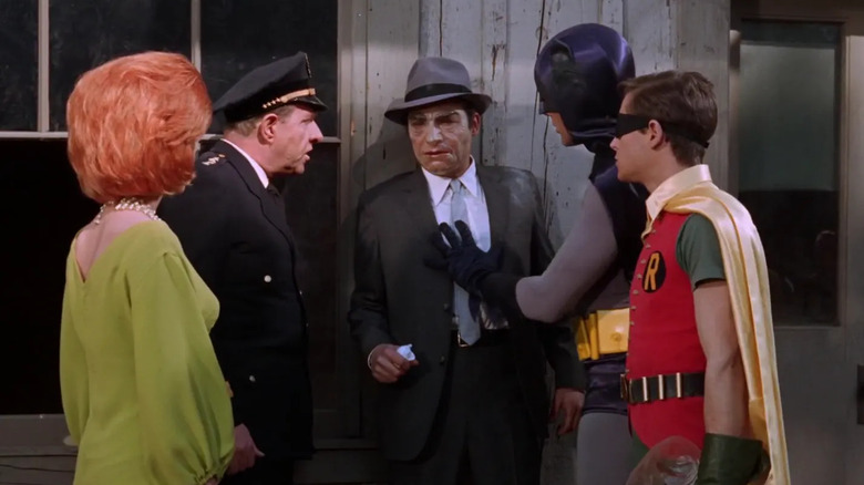 Blaze, Chief O'Hara, Batman, and Robin surrounding False Face on Batman
